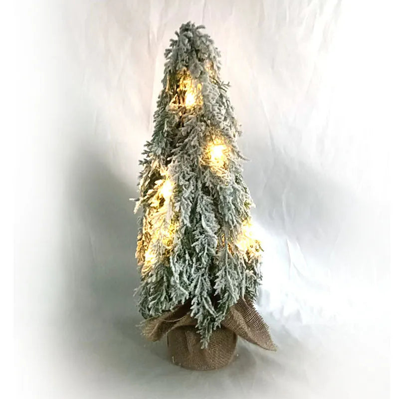 Small 24 inch white Christmas tree with built-in lights and simulated snow sprayer effect on branches