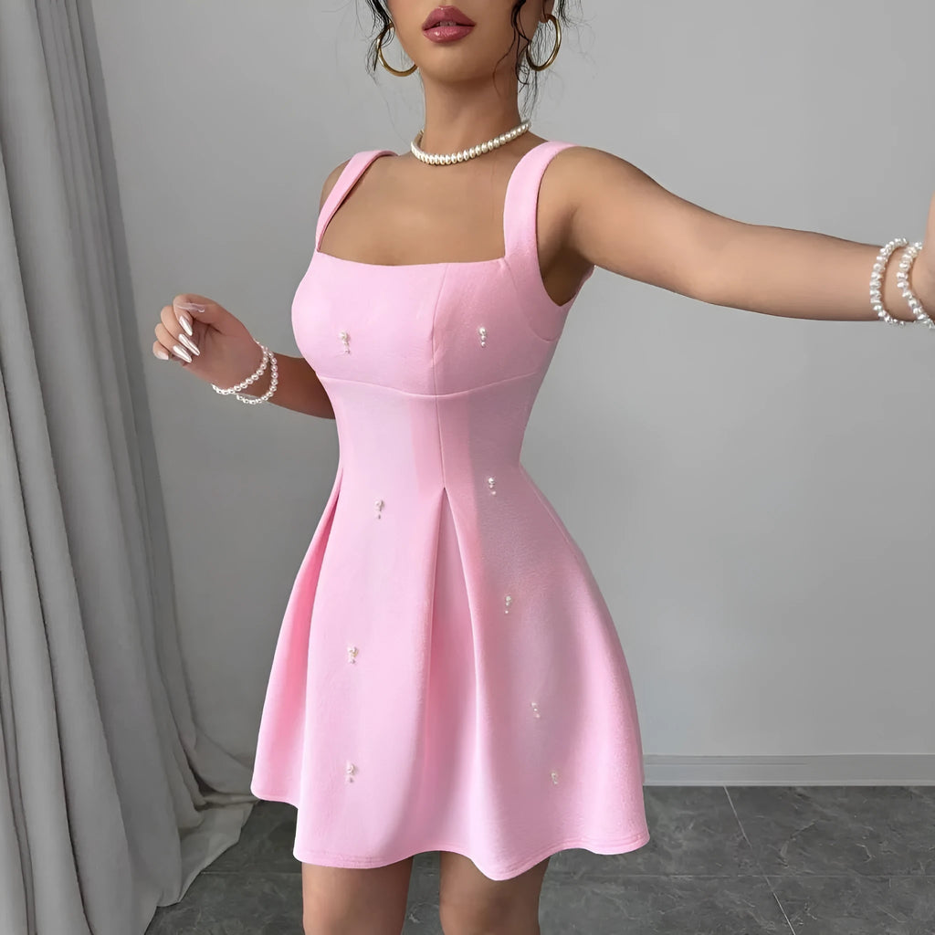 Pink high-waist A-line suspenders dress with short sleeveless skirt in polyester, shown on a model