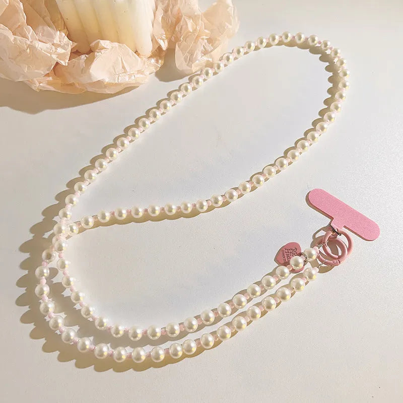 Pink pearl bead mobile phone lanyard with crossbody shoelace and wrist strap on white background