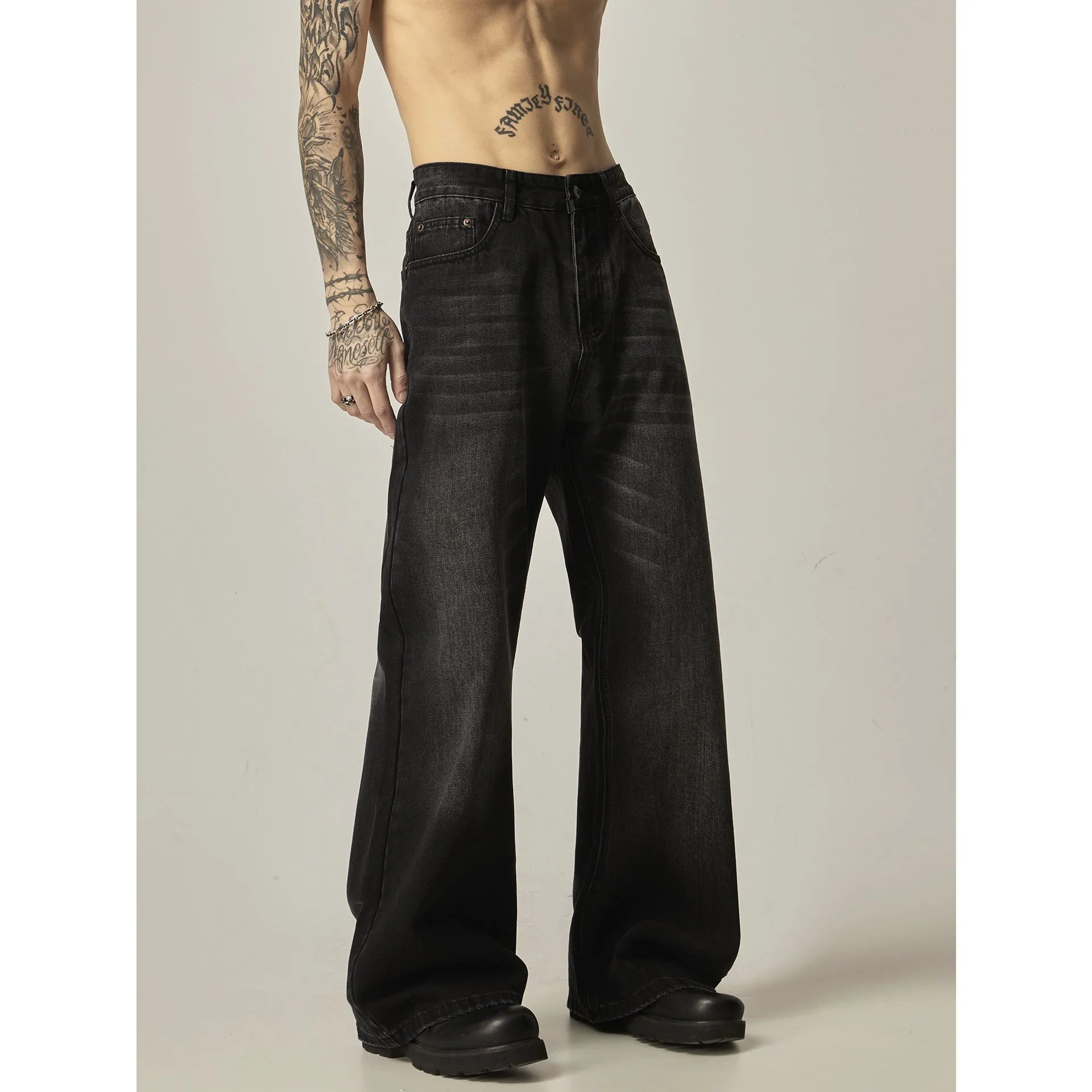 Black loose straight leg retro jeans on a hanger showing zipper fly detail
