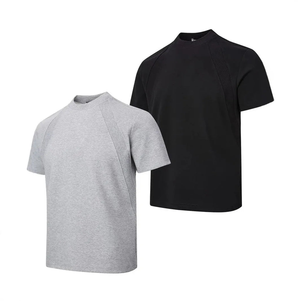 Man wearing a loose fit black short sleeve top with visible air layer stitching detail.