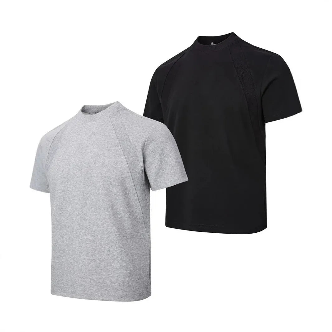 Man wearing a loose fit black short sleeve top with visible air layer stitching detail.