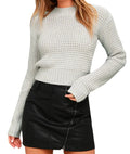 Man wearing a slim fit light grey acrylic knitted pullover jumper with a round neck and long sleeves.