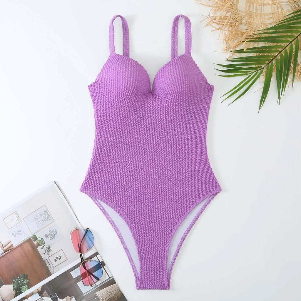 Women's black sunken stripe one-piece swimsuit made from polyester fabric, shown sleeveless.