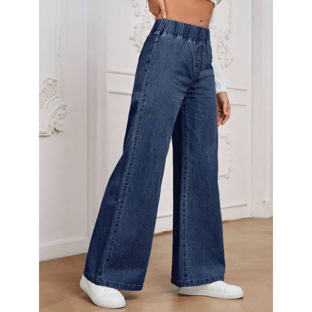 Light blue washed wide-leg denim jeans on a plus-size model, showing straight leg and mid-rise waist.