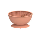 Cyan silicone dog bowl with raised licking mat texture and suction cup base on a floor.
