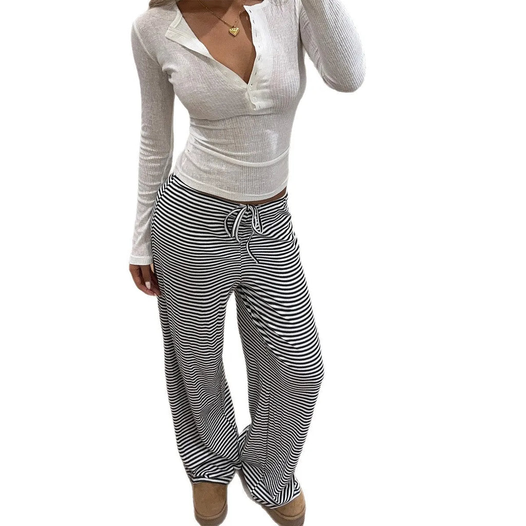 Women's mid-rise straight-leg trousers in black and white stripe pattern, polyester fabric, front view