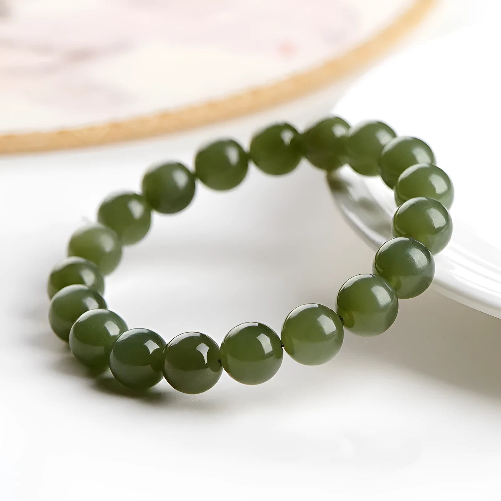 Polished Hetian jade bead bracelet showing deep water clear and light water clear colour options.