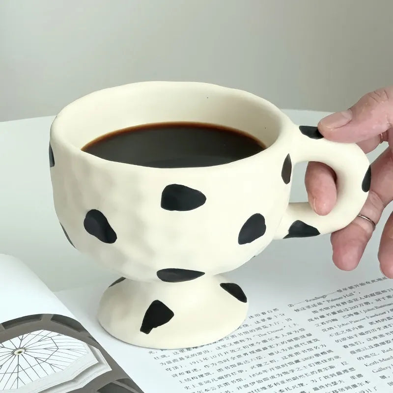 Hand-pinched irregular ceramic mug in a solid colour, shown from the side.