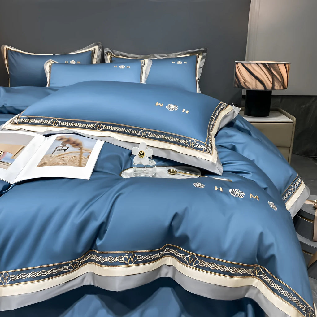 All-cotton light luxury four-piece bedding set with embroidery, available in multiple colours, on a bed