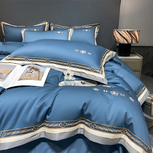 All-cotton light luxury four-piece bedding set with embroidery, available in multiple colours, on a bed