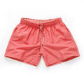 Men's black polyester beach shorts with a straight leg, shown on a size chart with options up to 4XL.