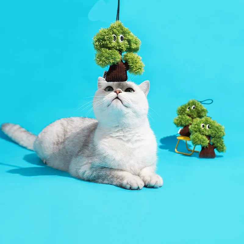 Green pine tree shaped fabric cat toy bag with hanging loop.