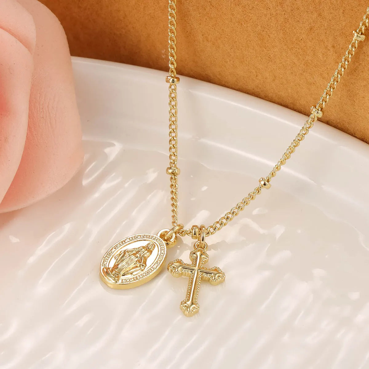 Gold cross Virgin Mary pendant necklace with geometric design on adjustable chain for women