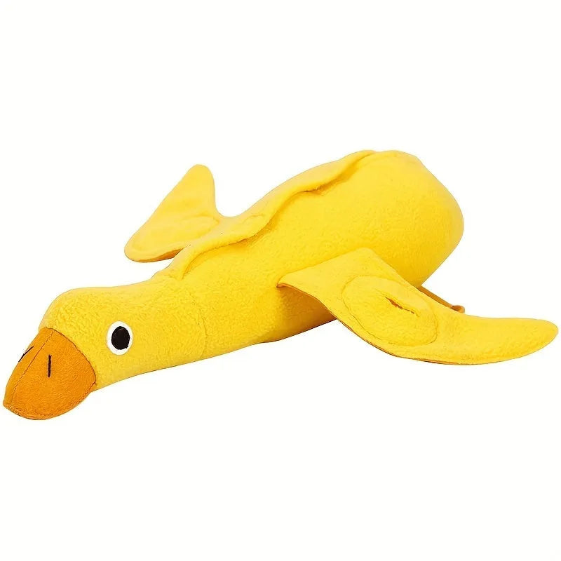 Yellow plush duck dog toy with squeaker and treat-dispensing feature for training and play.