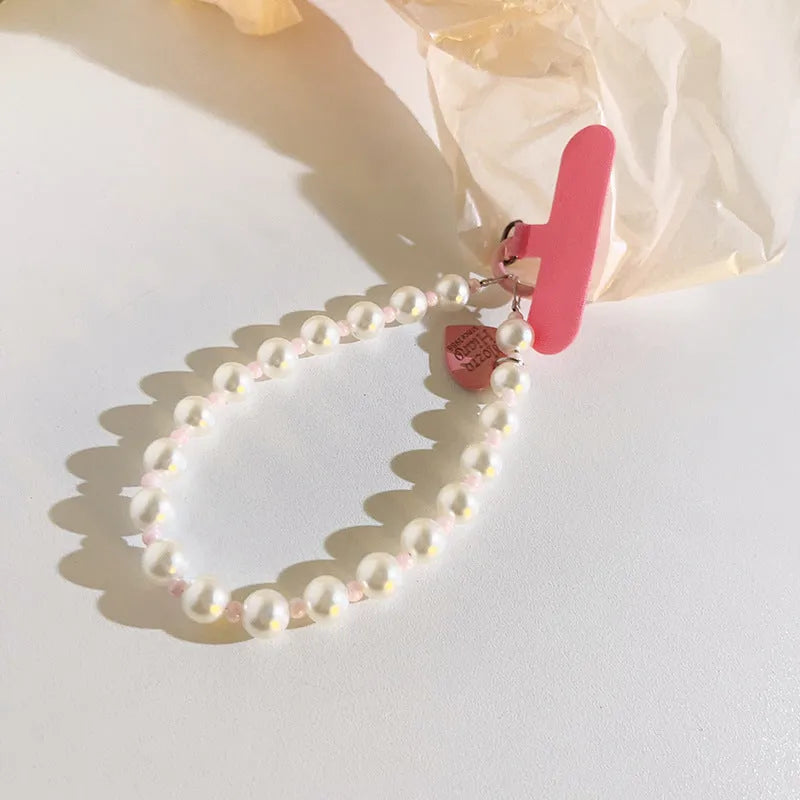 Pink pearl bead mobile phone lanyard with crossbody shoelace and wrist strap on white background