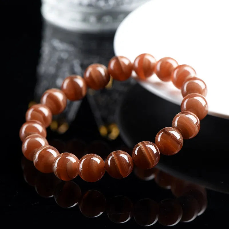 Peruvian rhodochrosite bracelet with geometric round beads in traditional ruyi design