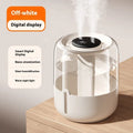 Beige round USB humidifier with dual spray nozzles and digital humidity display on a desk
