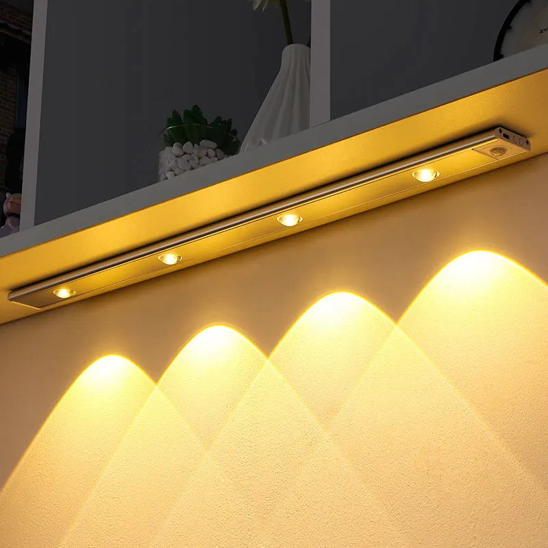 Silver ultra-thin LED light strip with motion sensor mounted inside a wooden wardrobe.