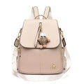Genuine leather women's student travel backpack with pendant in beige colour, featuring covered outer pocket and belt decoration
