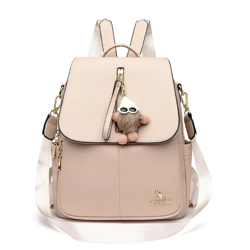 Genuine leather women's student travel backpack with pendant in beige colour, featuring covered outer pocket and belt decoration