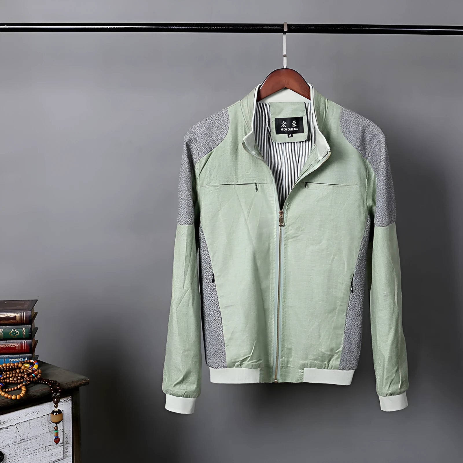 Men's thin blue cotton linen jacket on a hanger, showing regular cut and front button design.