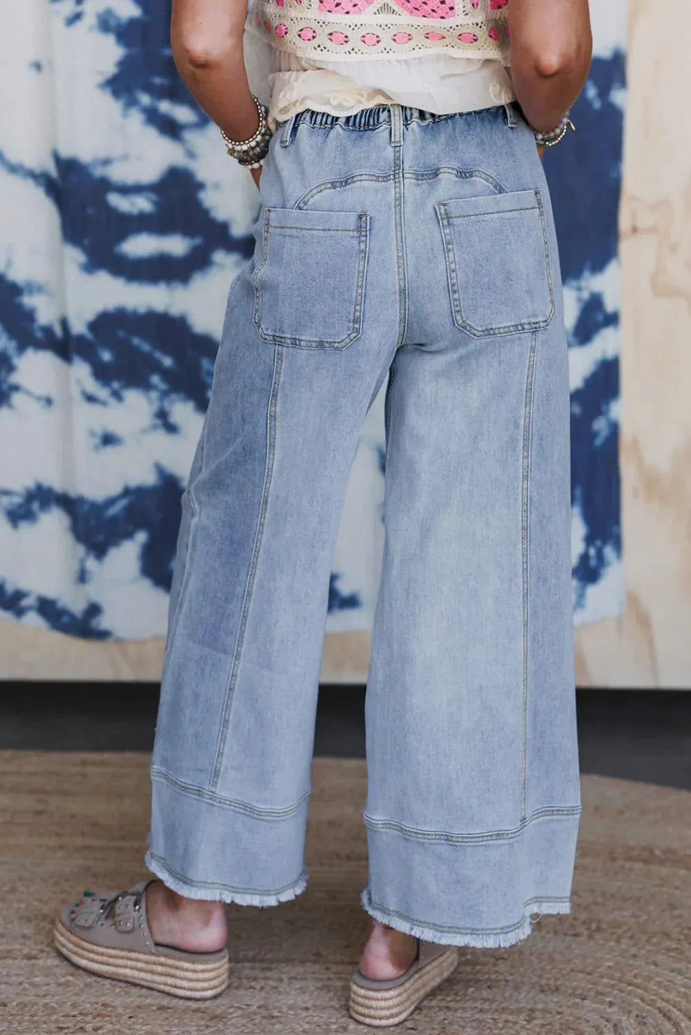 Beau blue wide leg denim pants with drawstring waist and raw hem seam detail