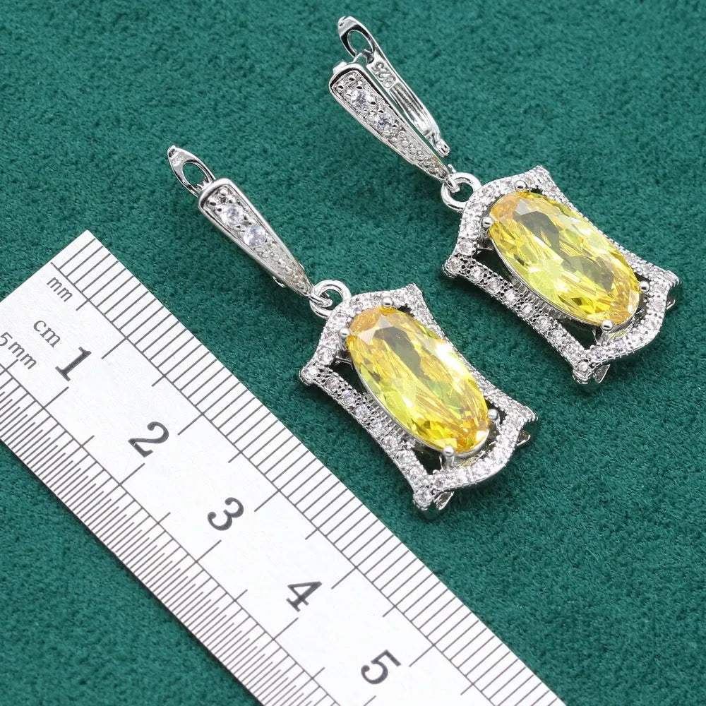 Yellow and olive alloy zircon jewellery set for women showing necklace, earrings, ring, and bracelet on display.