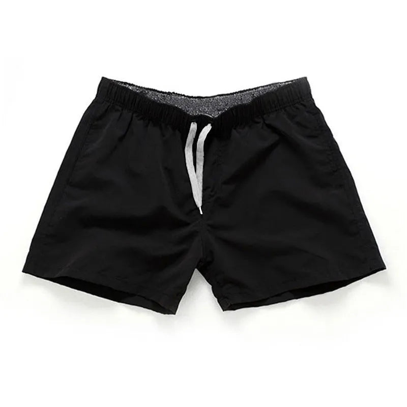 Men's black polyester beach shorts with a straight leg, shown on a size chart with options up to 4XL.