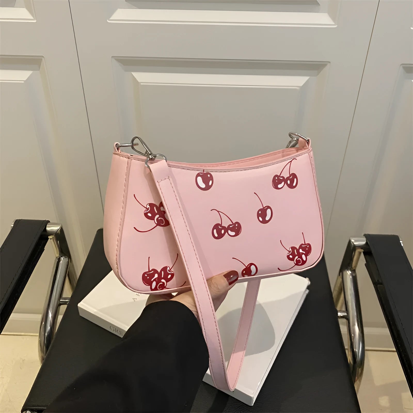 Casual PU underarm crossbody bag with floral print in black colour showing three-dimensional outer pocket