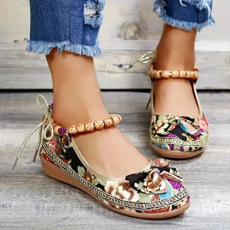 Women's black ethnic platform sandals with elastic band and cloth upper on a plus size foot.