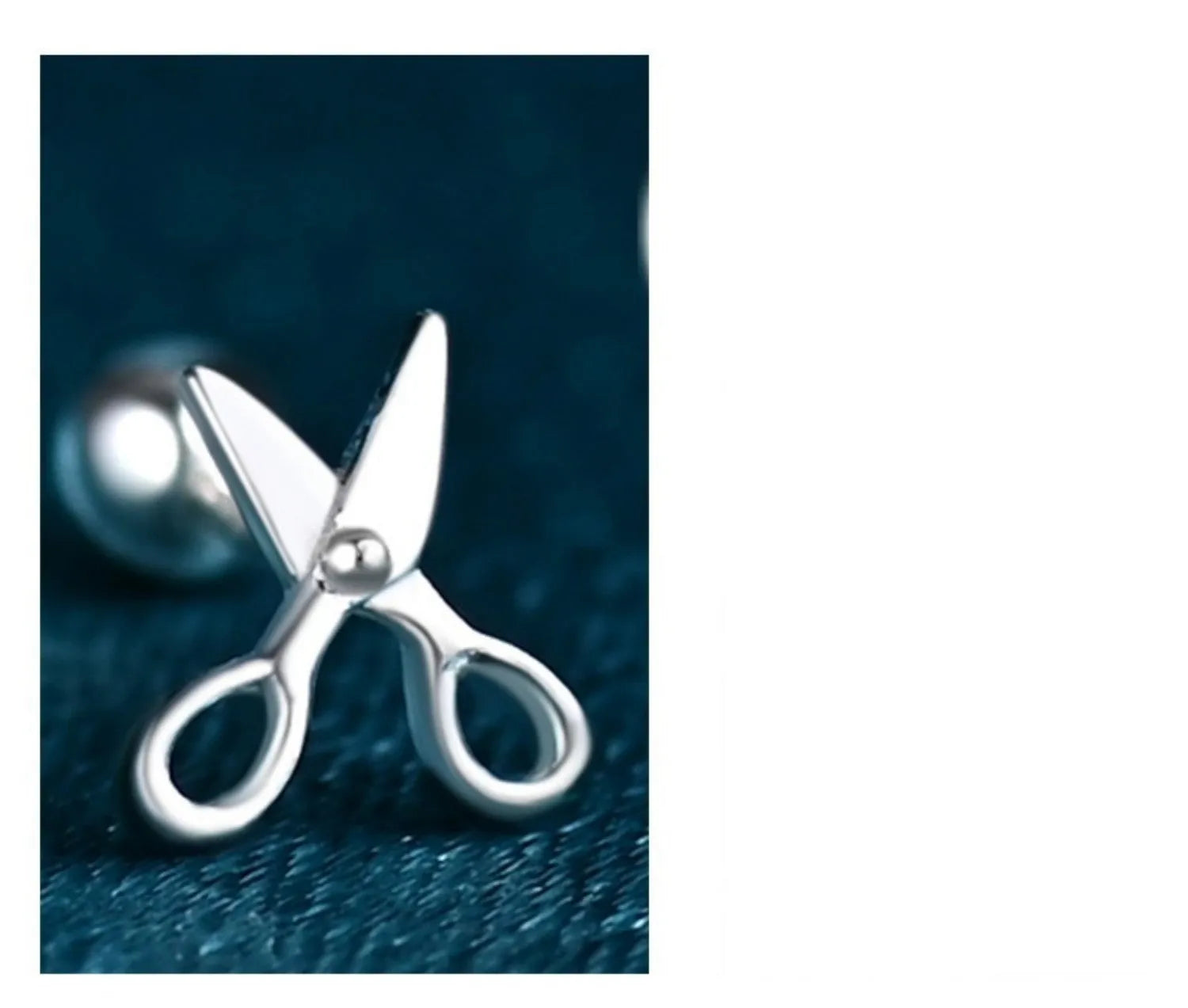 A pair of pure silver ear studs with a miniature scissors design on the screw-back fastener.