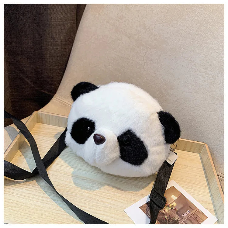 Soft plush crossbody bag with panda head design, cylindrical shape, and sandwich pocket