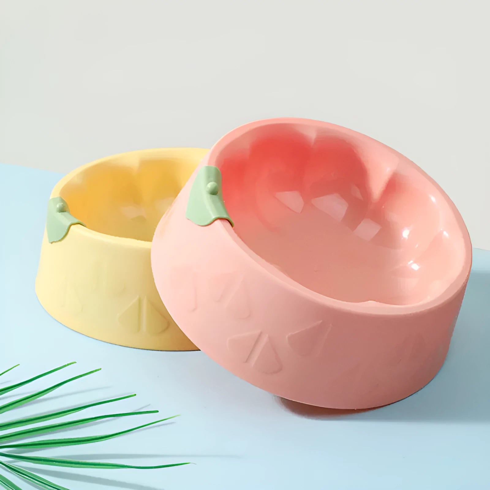 Green plastic double pet bowl with flower-shaped feeding areas and anti-tipping base design