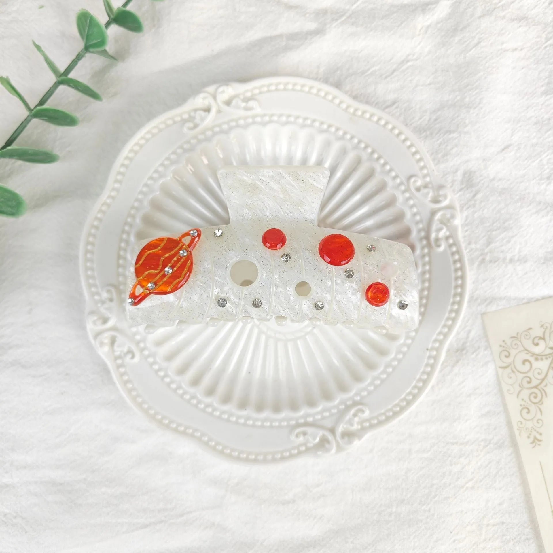 Oversized cellulose acetate hair barrette with star and moon pattern in starry sky design