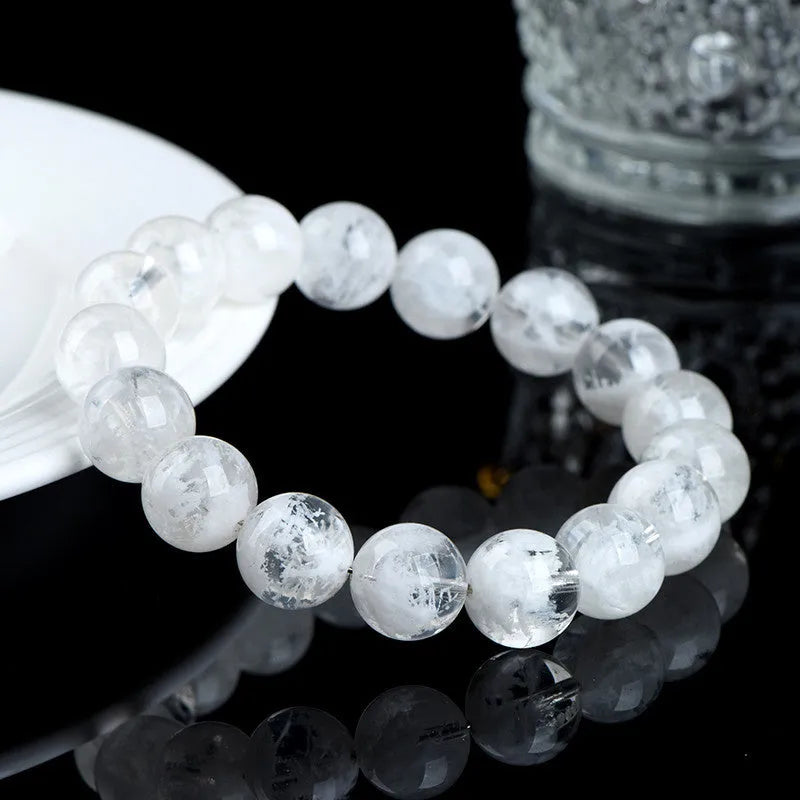 Close-up of a women's bracelet with round geometric crystal beads in a natural blizzard snowflake finish, showing Ruyi and Xiangyun design details.
