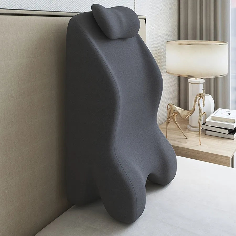 A stomach sleeping pillow shown in one of four colour options: blue, dark grey, green, or light grey.