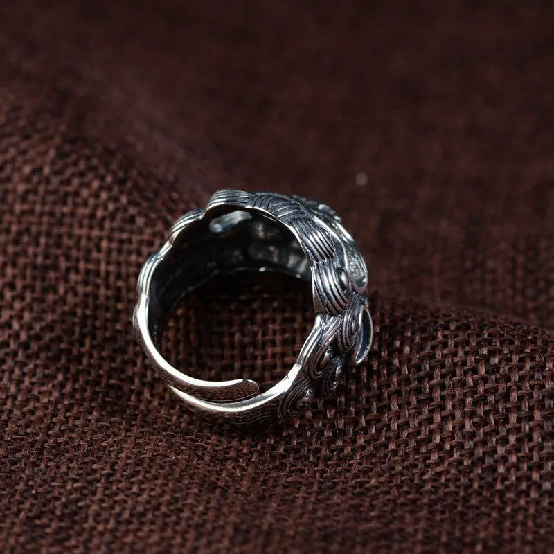Silver open ring with detailed jibeast animal zodiac pattern showing adjustable retro design