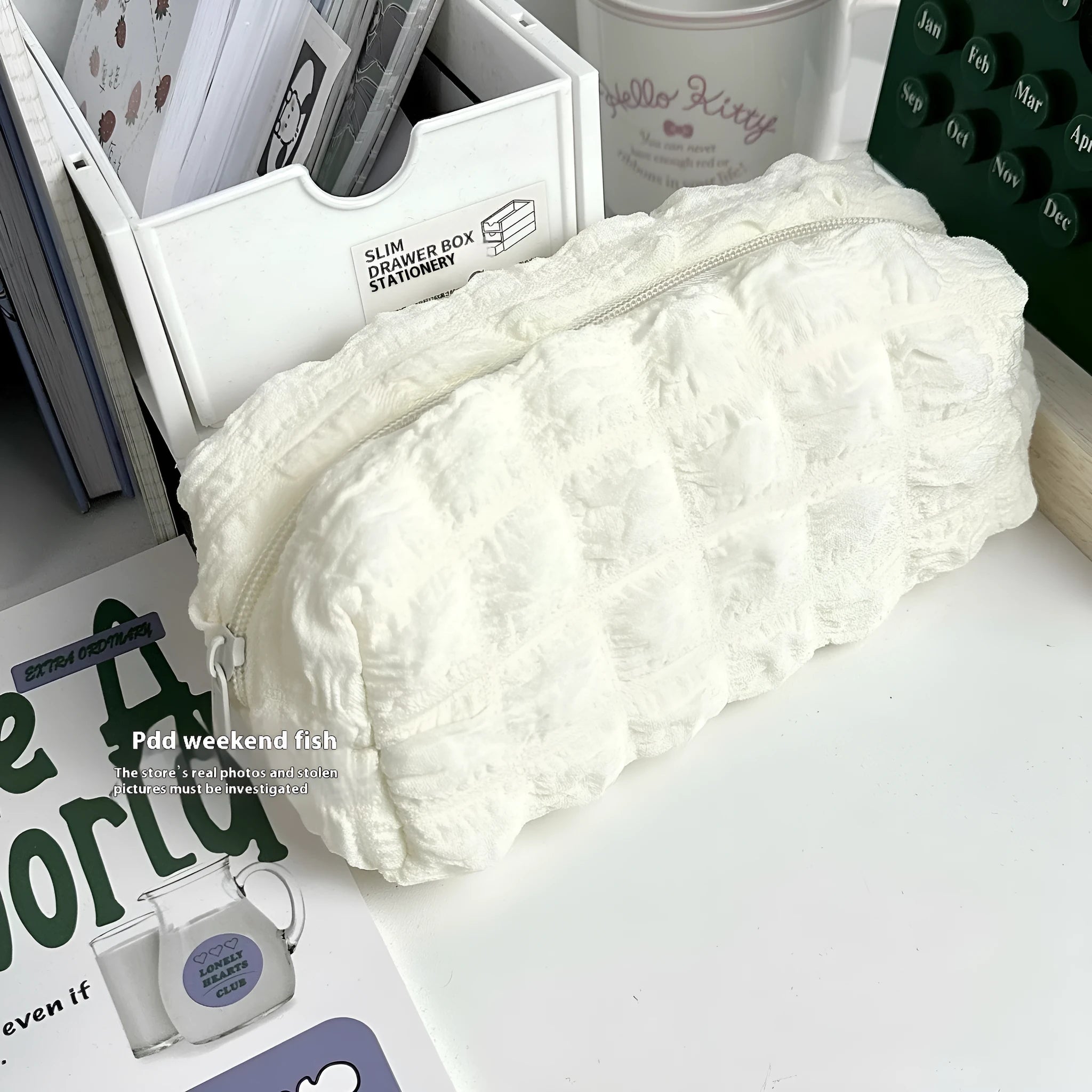 Cream puff style fabric pencil case in polyester construction showing beige and black colour options