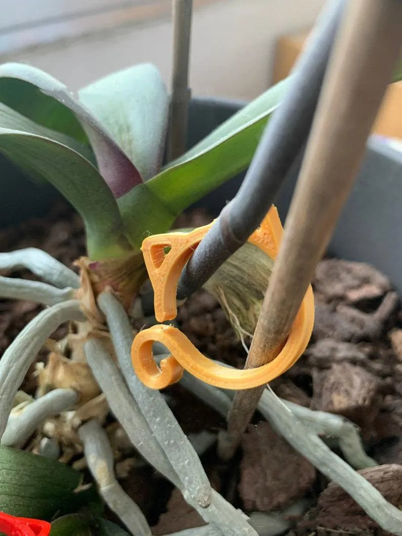 Small cat-shaped plastic plant clip in four colour options for indoor gardening support