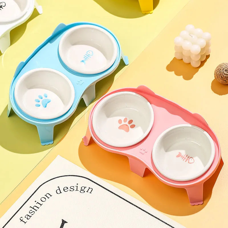 Ceramic cat food and water bowl set with elevated tilted stand in blue, pink, white, or yellow