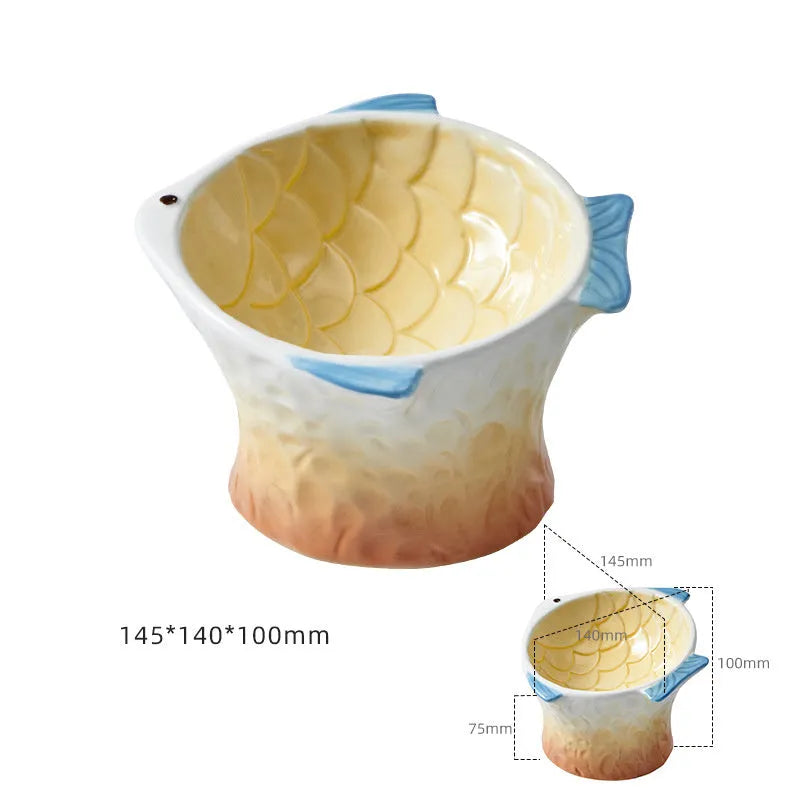 Set of four blue fish-shaped ceramic cat bowls with a tilted angle on a flat surface.