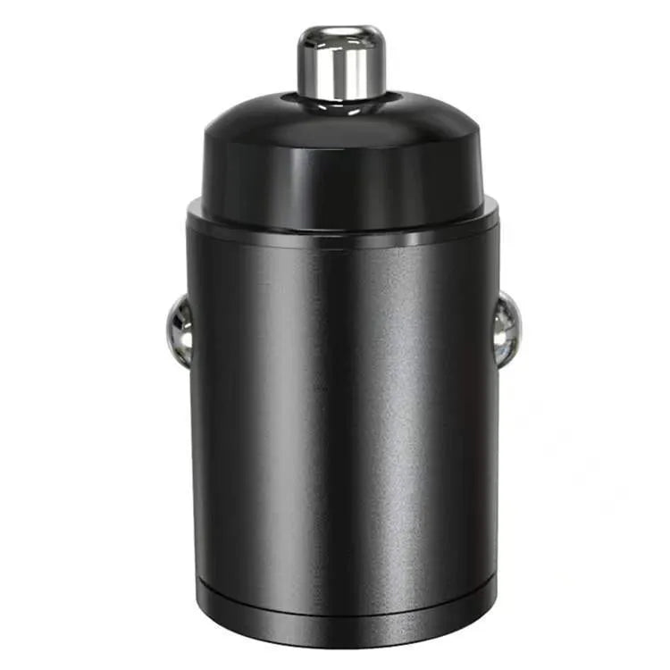Black mini 30W dual USB car charger with zinc alloy housing next to a car cigarette lighter socket.