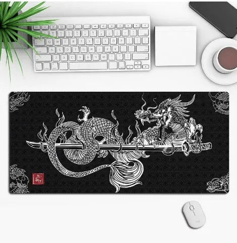 Large black gaming mouse pad with an anime character print, lying flat on a wooden desk.