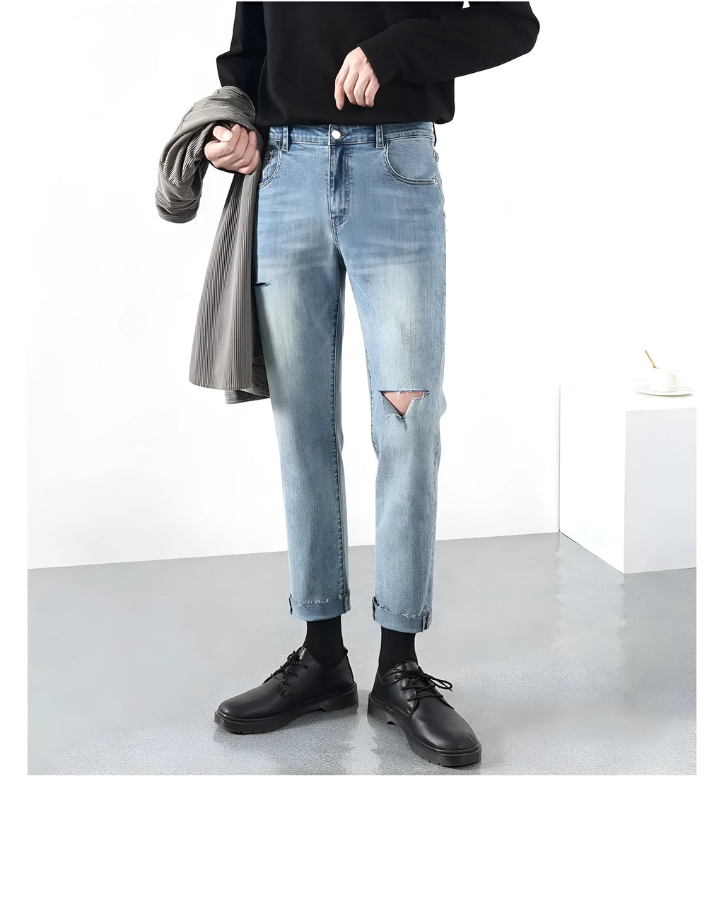 Men's light blue ripped jeans with microelastic cotton blend fabric, shown flat for size reference