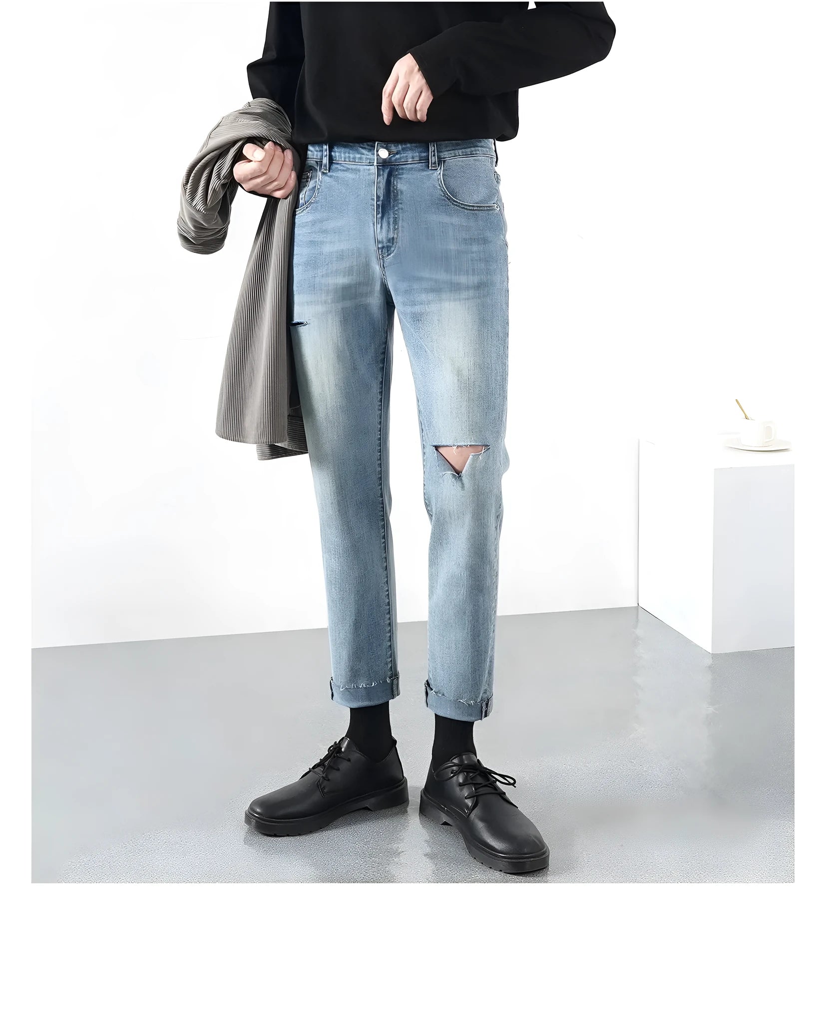 Men's light blue ripped jeans with microelastic cotton blend fabric, shown flat for size reference