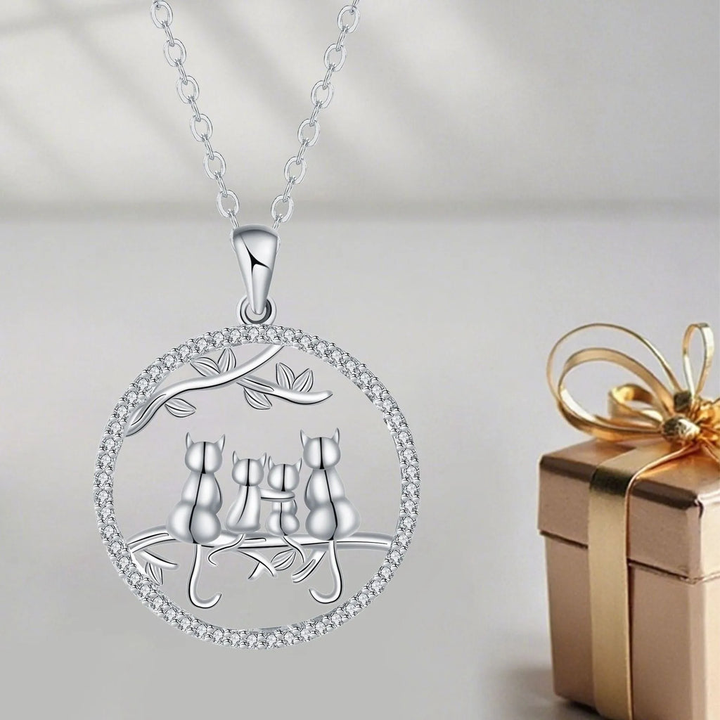 Four kitten pendant necklace on a copper cross chain with electroplated finish.