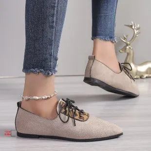 Beige leopard print women's pointed toe pumps on a white background, side view.