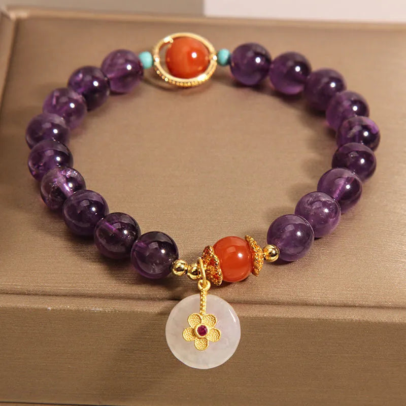 Natural amethyst bracelet with sliding knot and small flower inlay on a white background