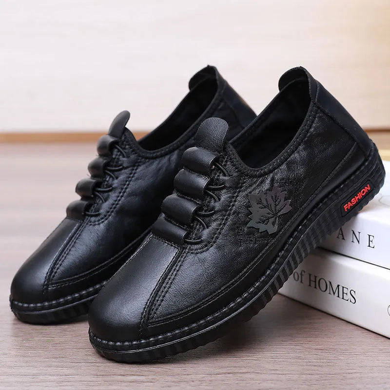 Plus size PU soft bottom slip-on mom shoes in black with leaf pattern, flat heel, and shallow mouth design